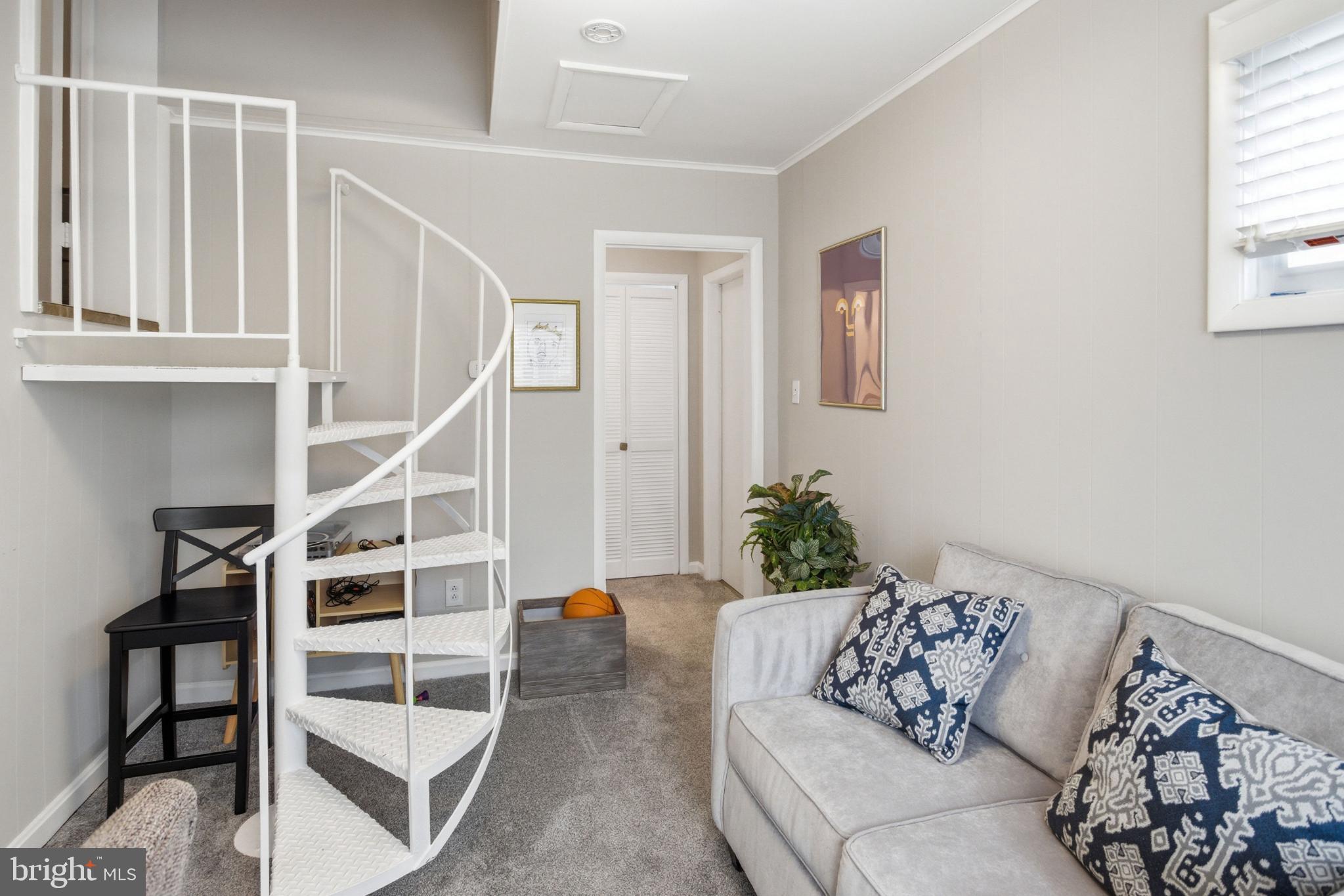 8802 Parliament Drive Springfield, VA 22151 - Photo 14 of 47 Charming spiral staircase in cozy living space.