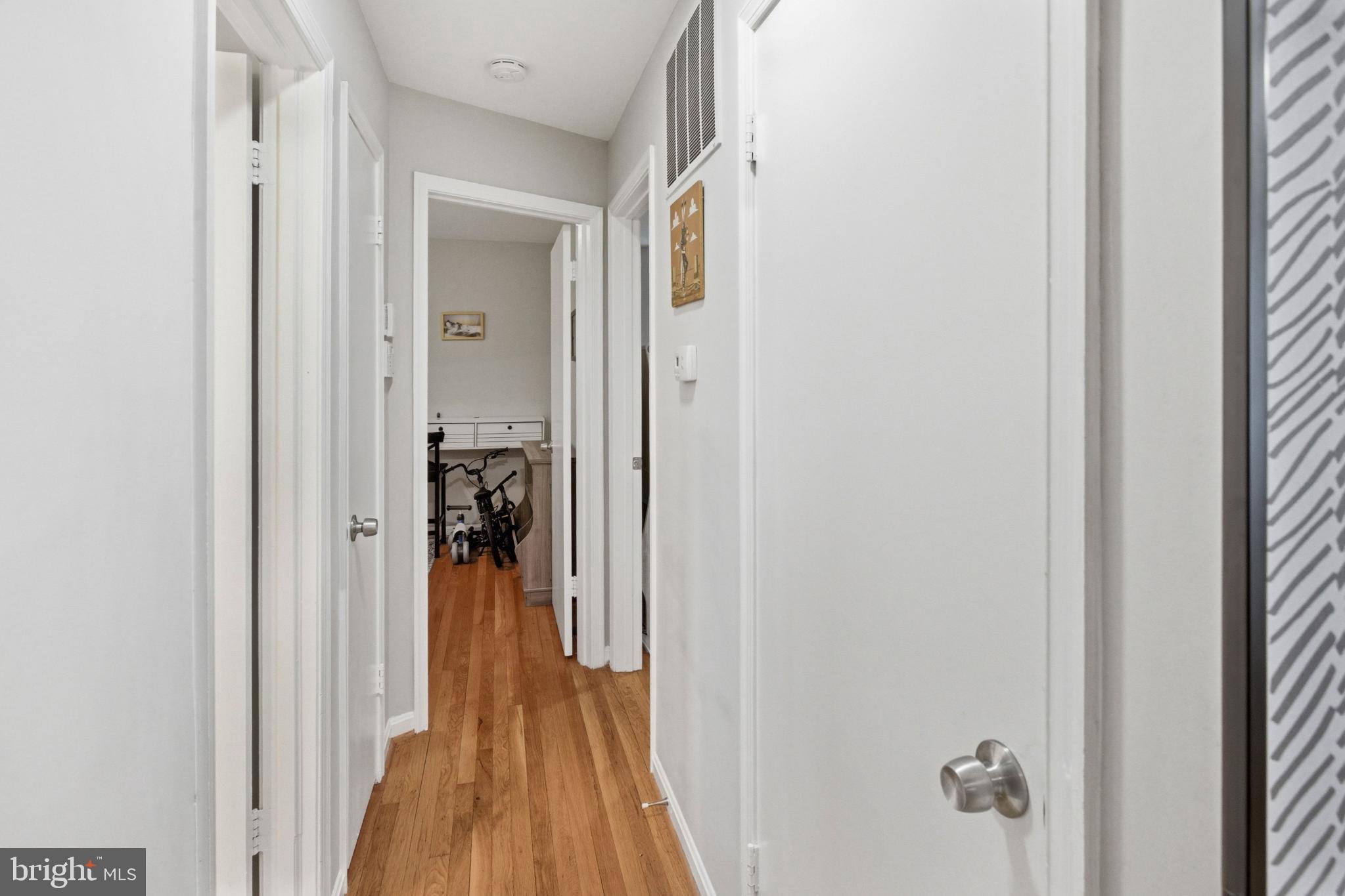 8802 Parliament Drive Springfield, VA 22151 - Photo 19 of 47 Inviting hallway with warm wooden floors.