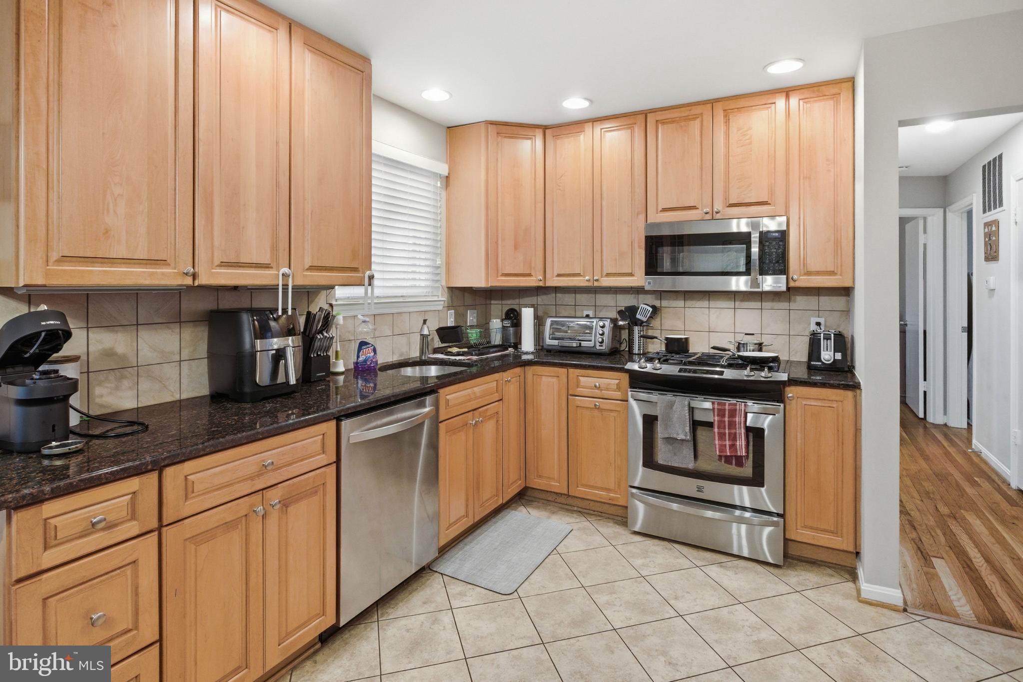 8802 Parliament Drive Springfield, VA 22151 - Photo 8 of 47 Modern kitchen with warm wood cabinetry.