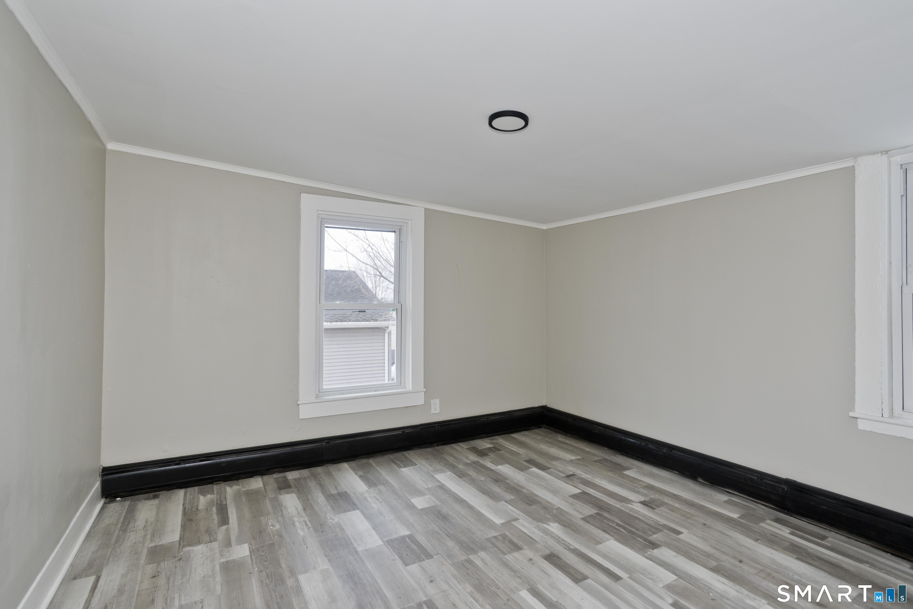 47 Maple Avenue Enfield, CT 06082 - Photo 14 of 37 a view of empty room with wooden floor and fan