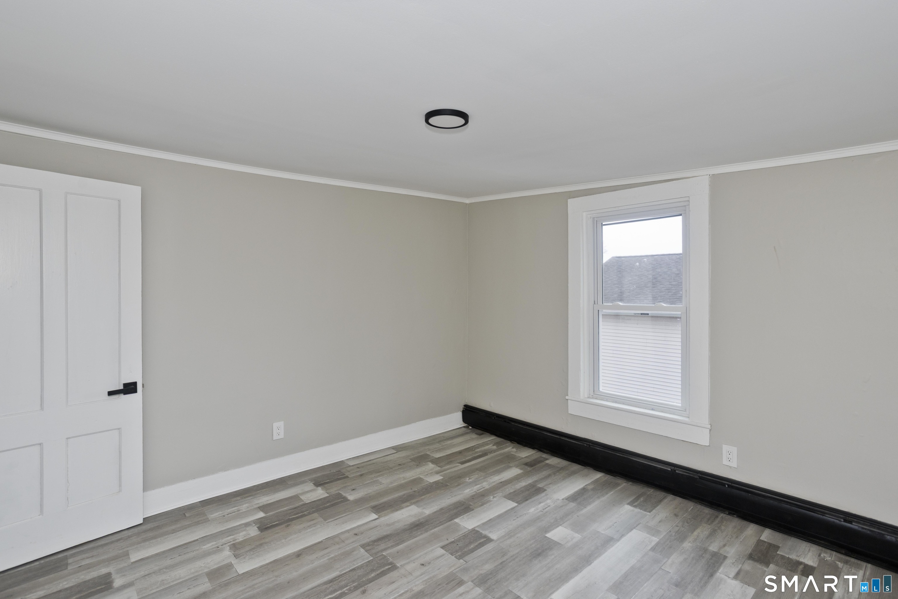 47 Maple Avenue Enfield, CT 06082 - Photo 15 of 37 a view of empty room with wooden floor and fan