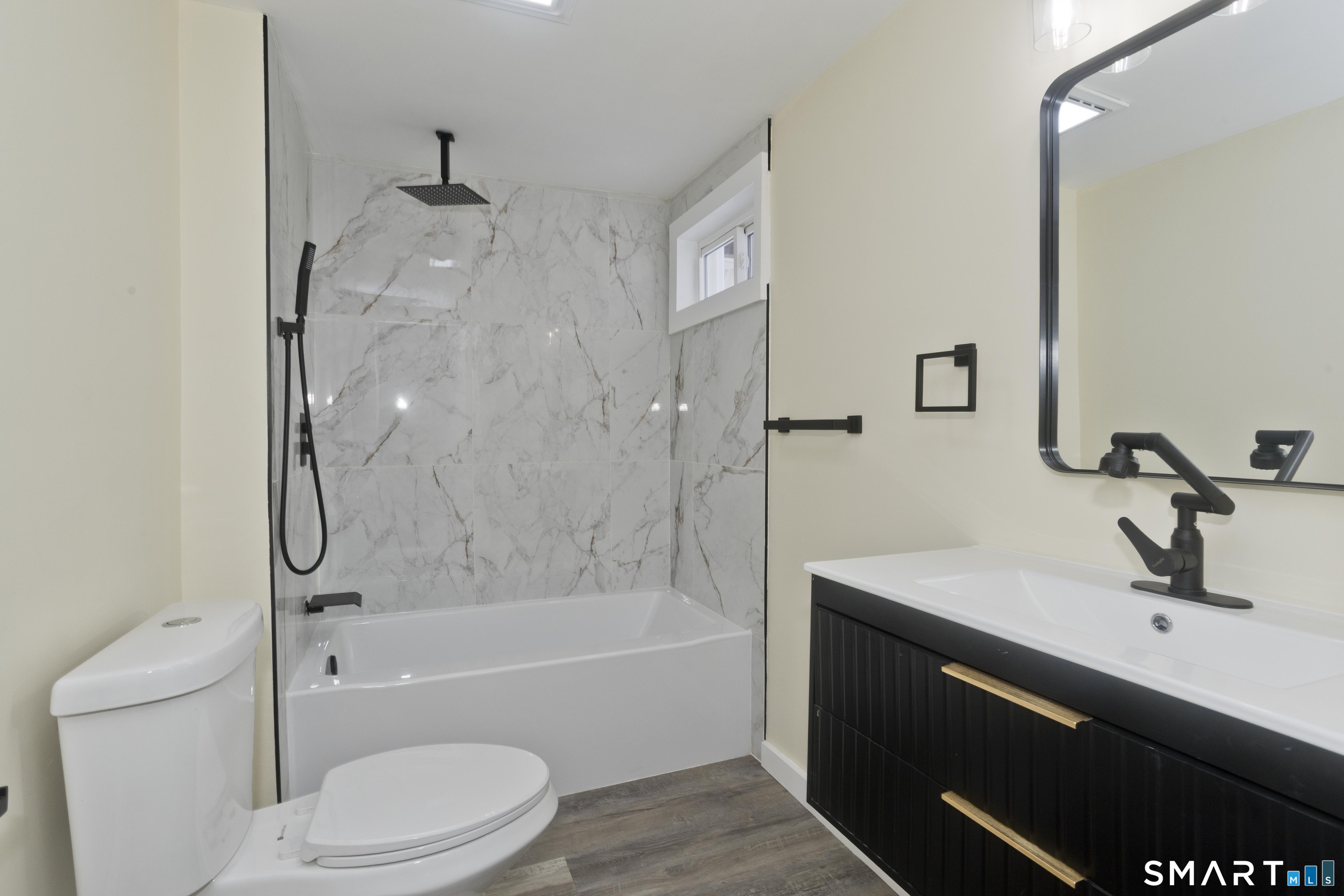 47 Maple Avenue Enfield, CT 06082 - Photo 26 of 37 a bathroom with a sink a toilet and a bathtub