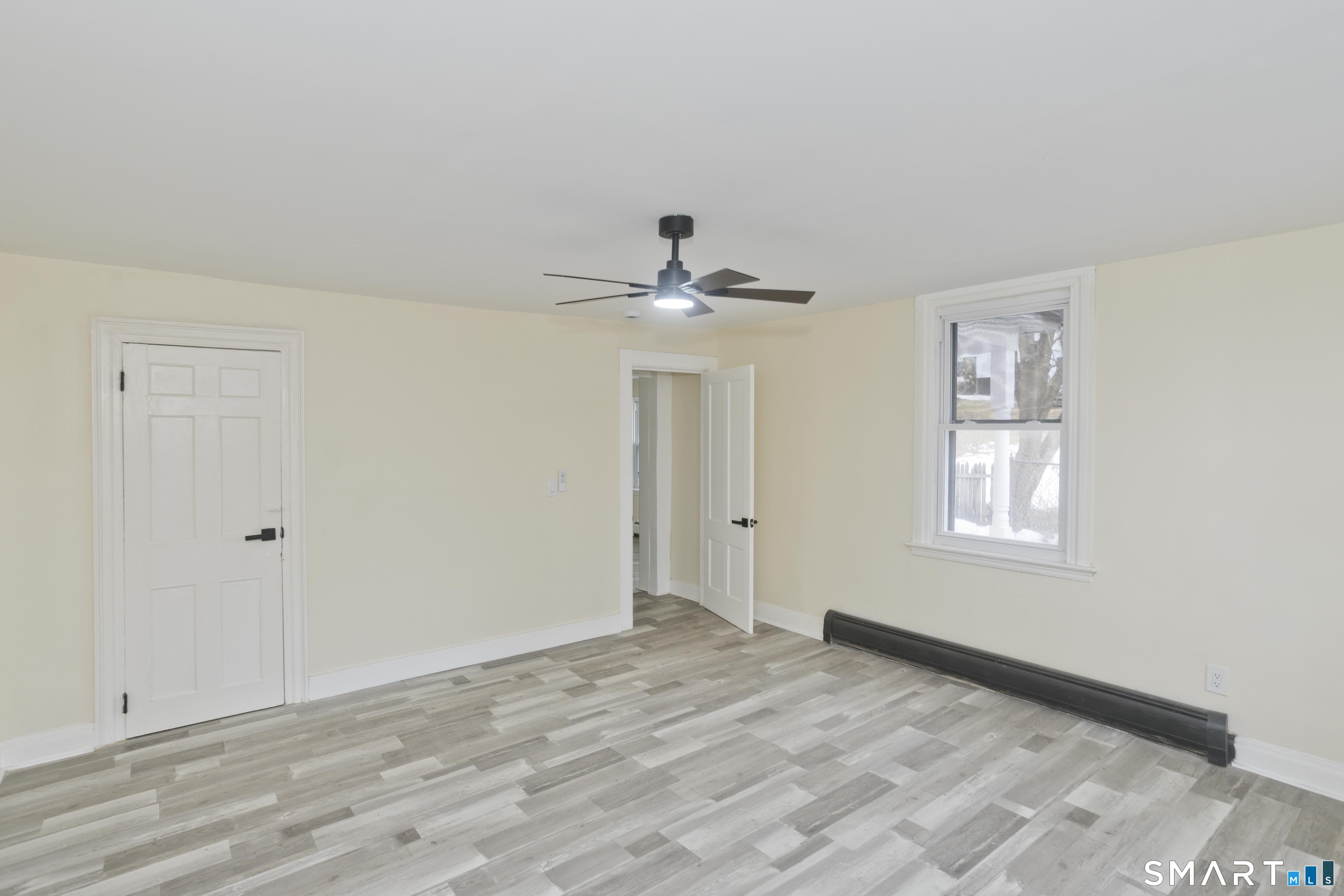 47 Maple Avenue Enfield, CT 06082 - Photo 33 of 37 a view of empty room with wooden floor and fan