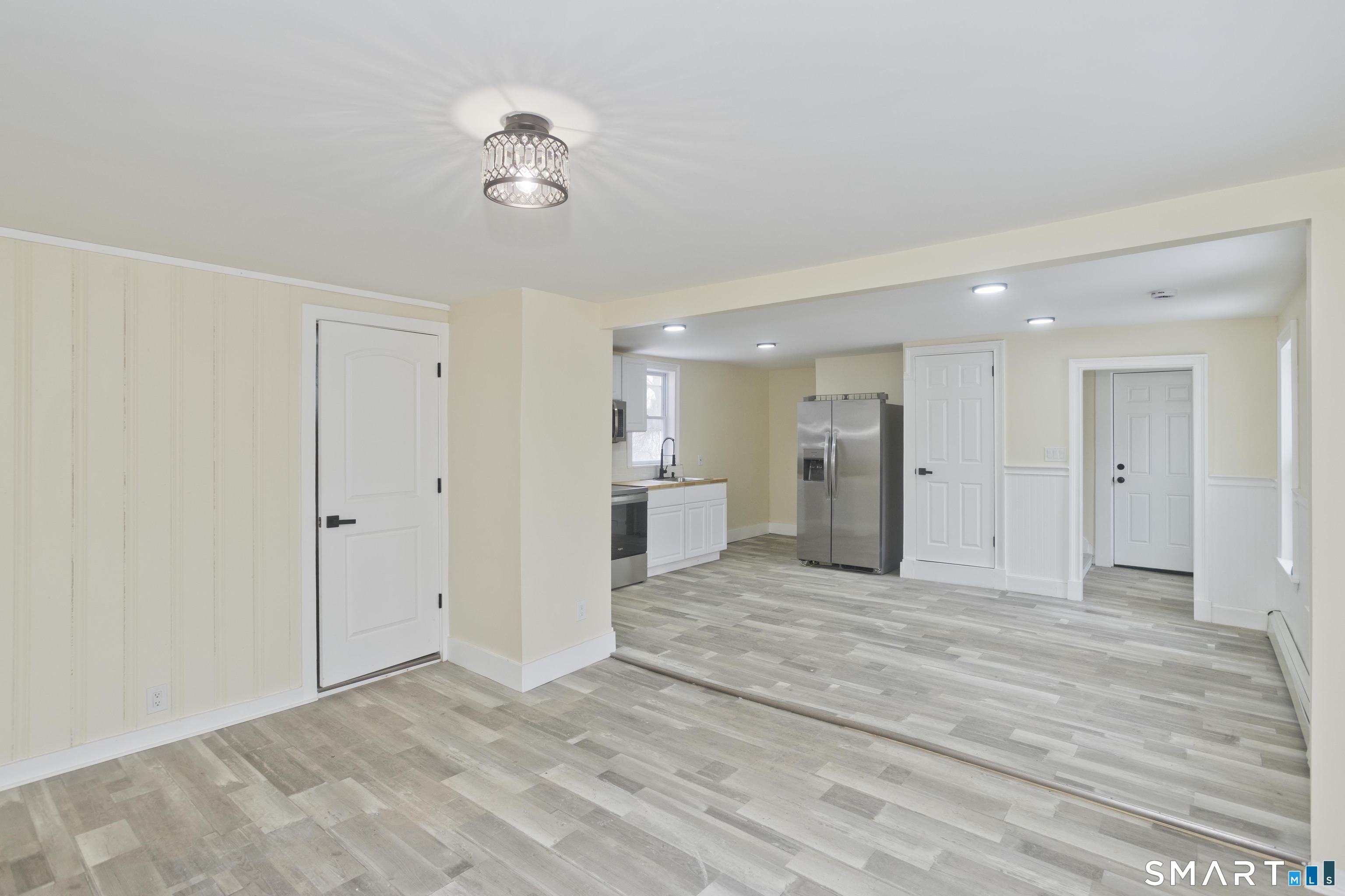47 Maple Avenue Enfield, CT 06082 - Photo 34 of 37 a view of an empty room with wooden floor and a ceiling fan