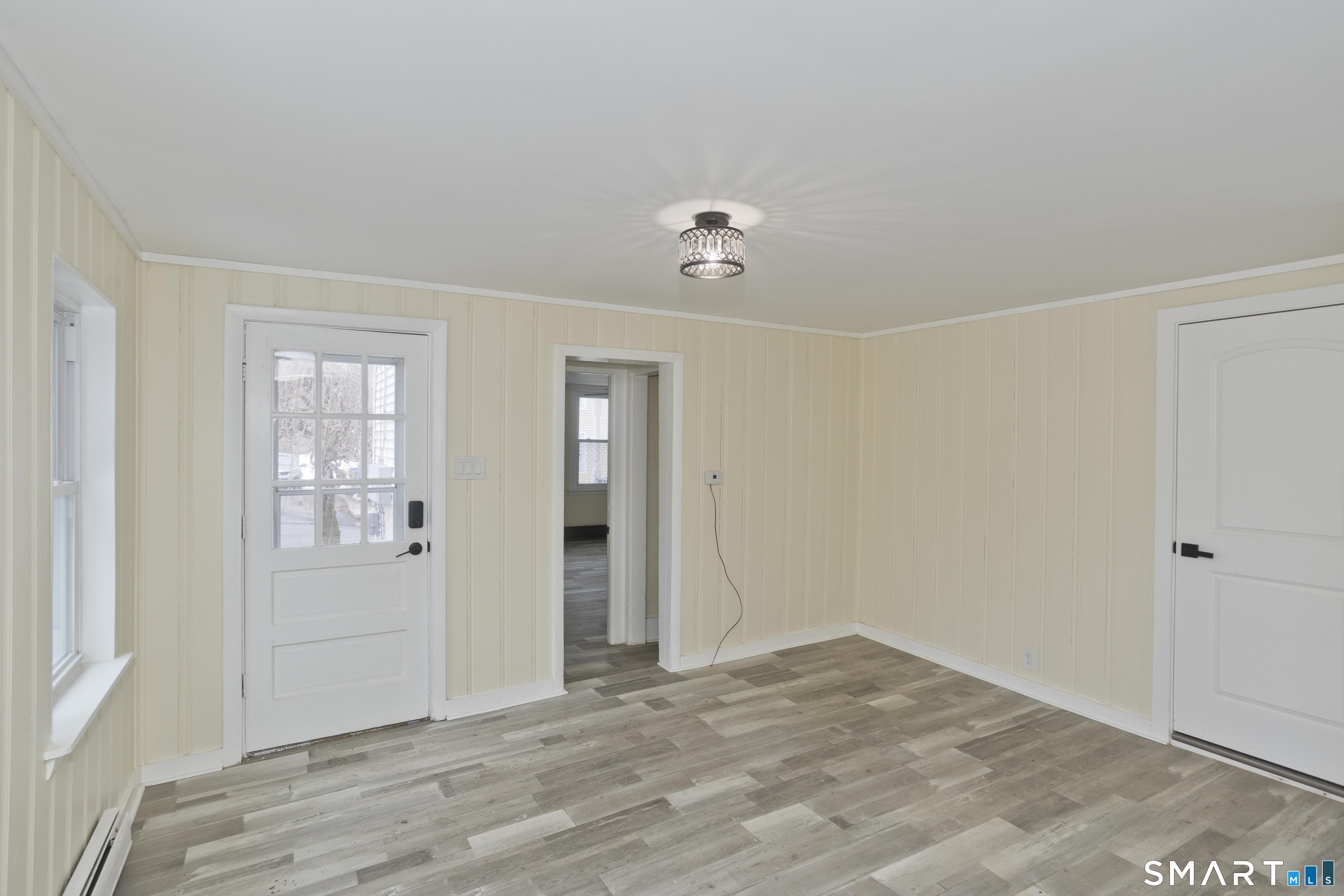 47 Maple Avenue Enfield, CT 06082 - Photo 37 of 37 a view of an empty room with wooden floor and windows