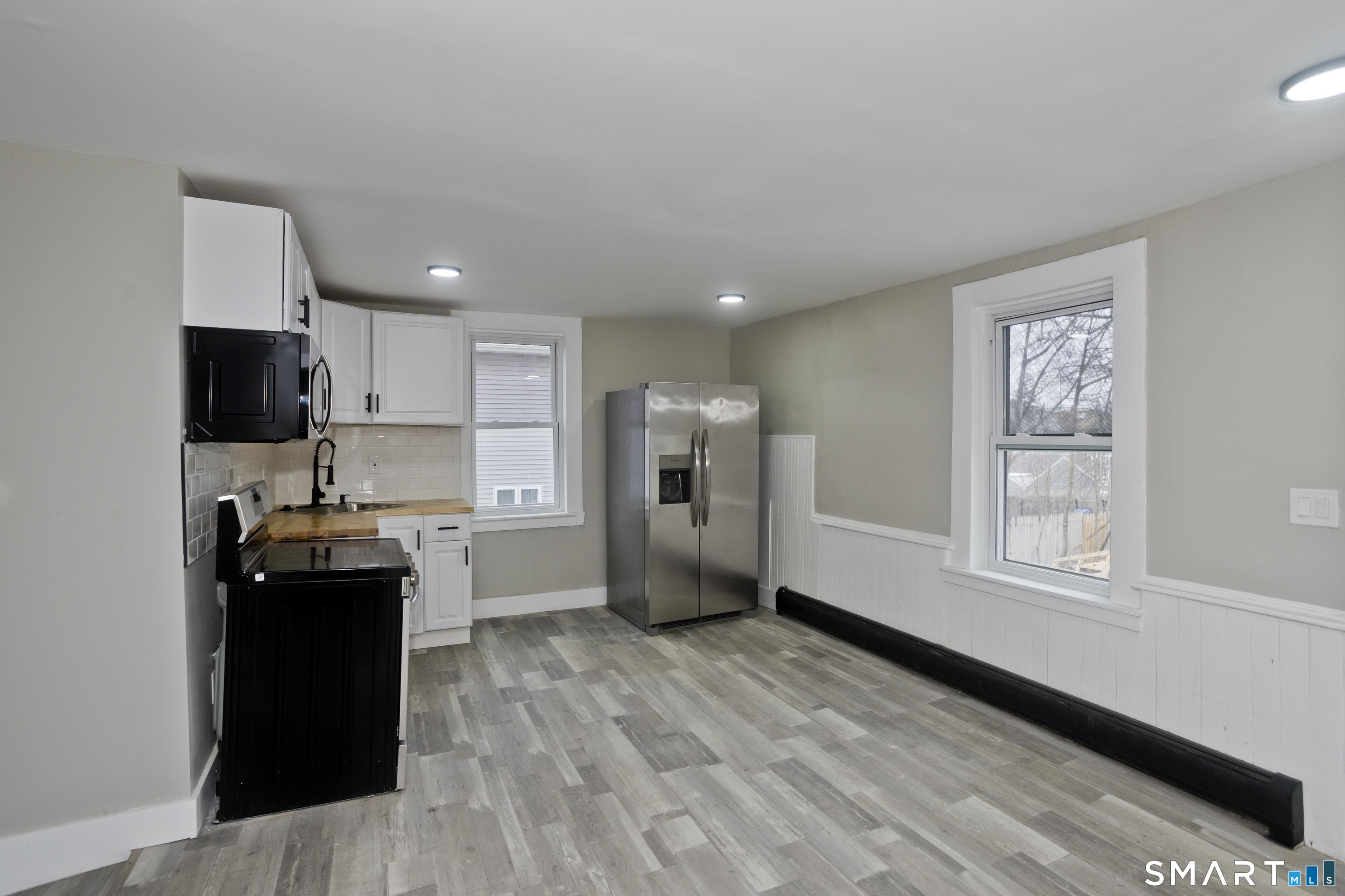 47 Maple Avenue Enfield, CT 06082 - Photo 5 of 37 a kitchen with a refrigerator and a stove top oven