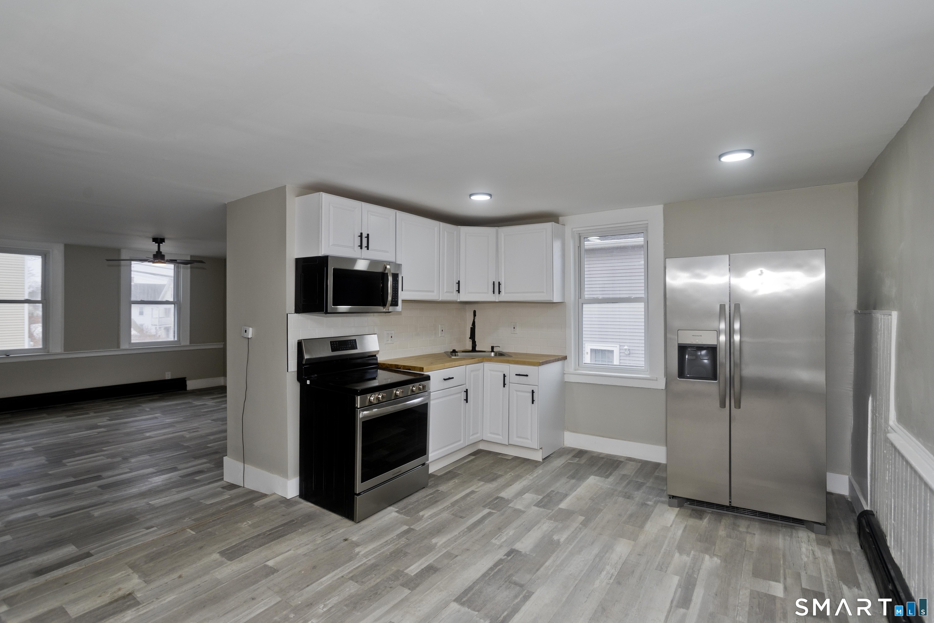 47 Maple Avenue Enfield, CT 06082 - Photo 5 of 36 a kitchen with stainless steel appliances granite countertop a stove a sink and a refrigerator