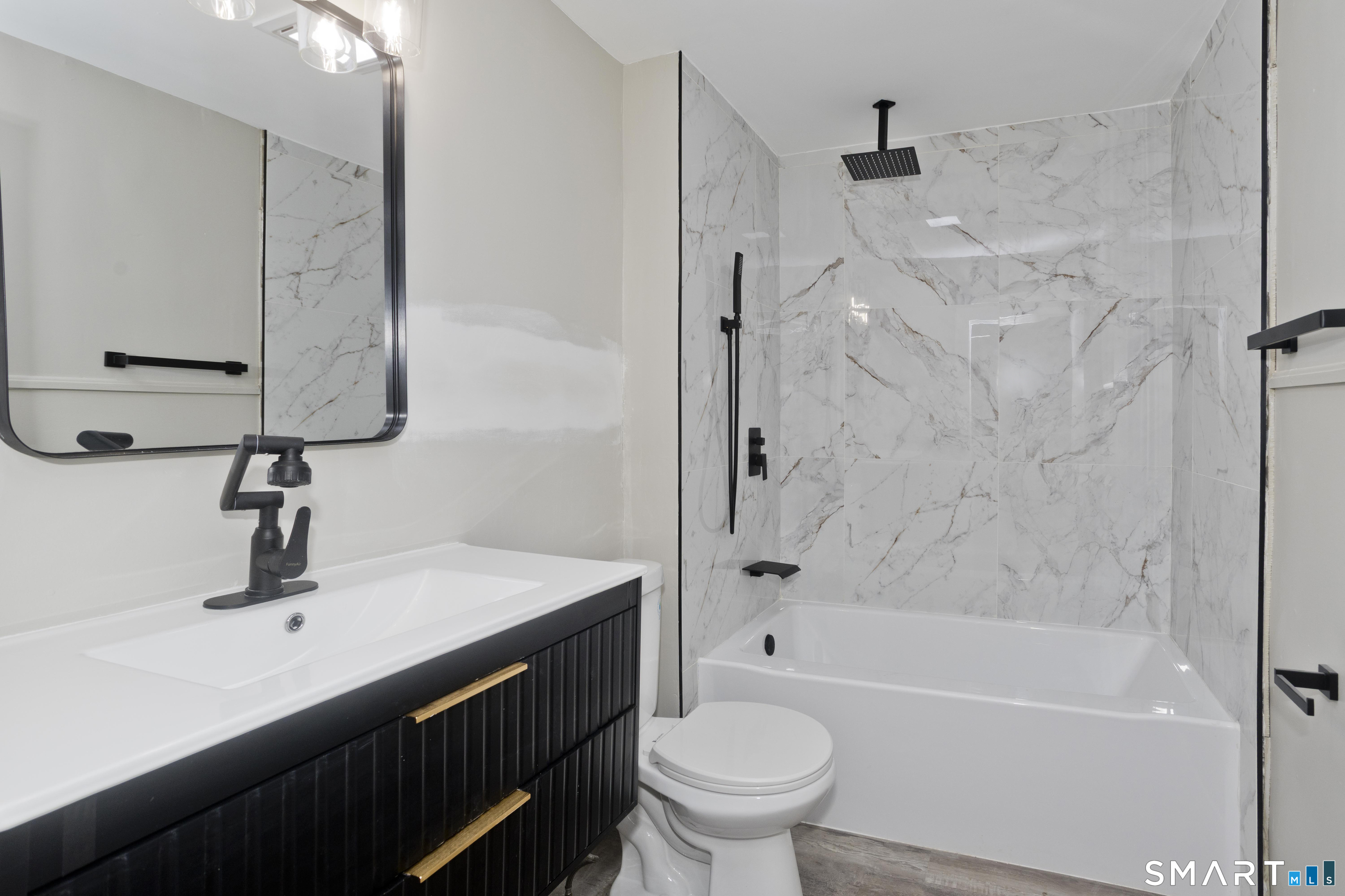 47 Maple Avenue Enfield, CT 06082 - Photo 8 of 36 a bathroom with a sink a toilet and shower
