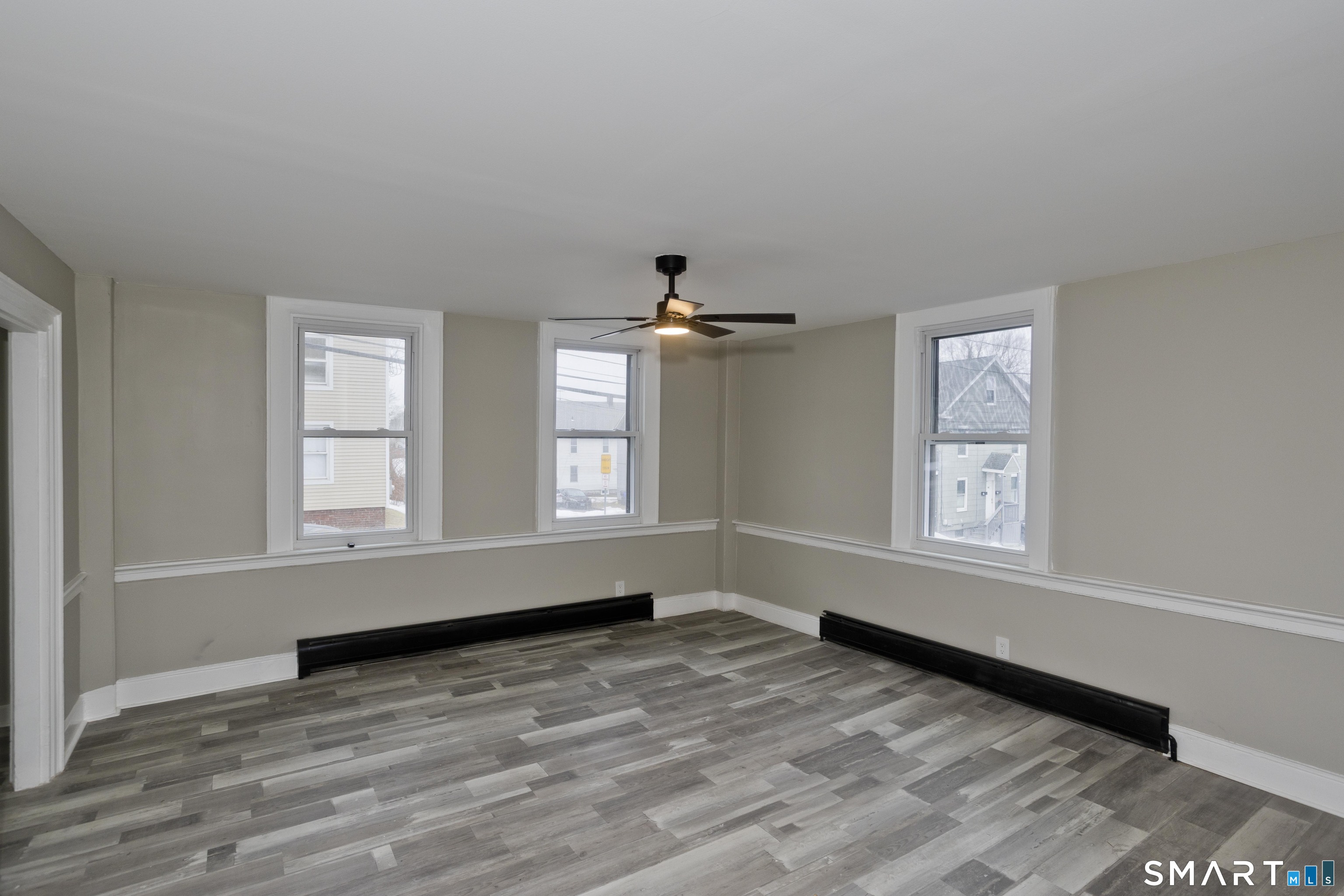 47 Maple Avenue Enfield, CT 06082 - Photo 9 of 36 an empty room with wooden floor and windows