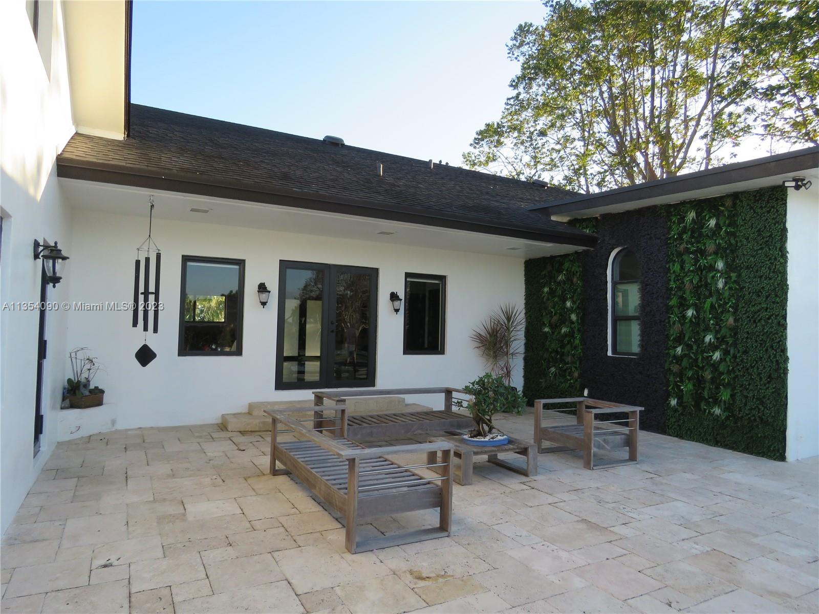 Redlands Homestead, FL 33031 - Photo 15 of 56 a view of a patio with table and chairs and potted plants