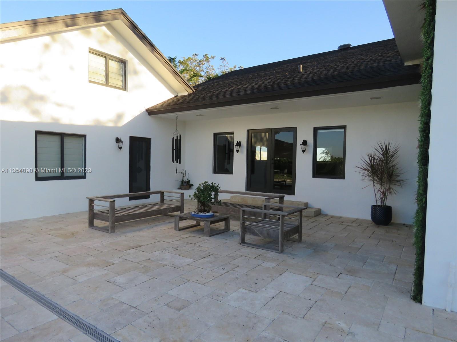 Redlands Homestead, FL 33031 - Photo 17 of 56 a view of a house with patio and a garden