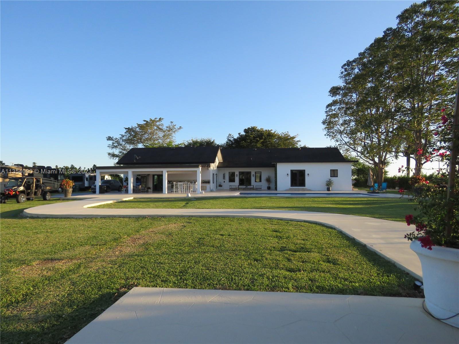 Redlands Homestead, FL 33031 - Photo 19 of 56 a front view of a house with a garden