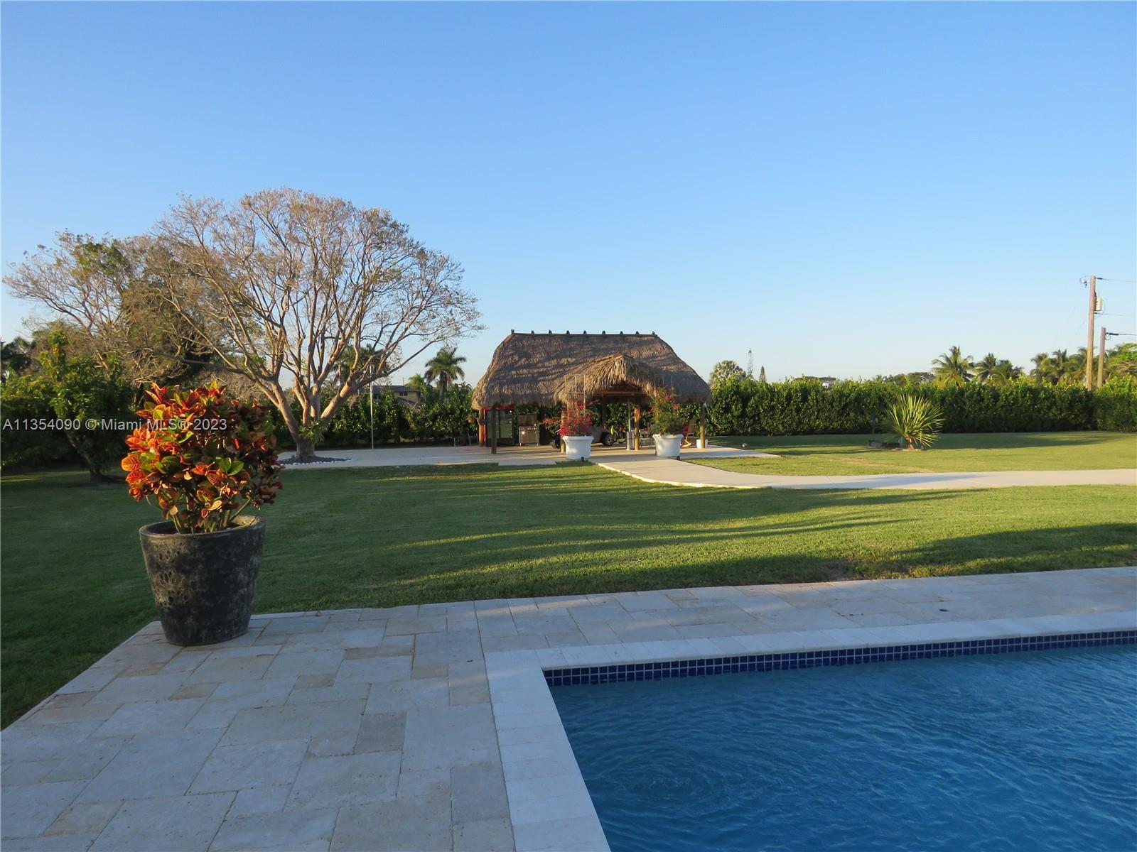 Redlands Homestead, FL 33031 - Photo 23 of 56 a view of a house with a yard and a large tree