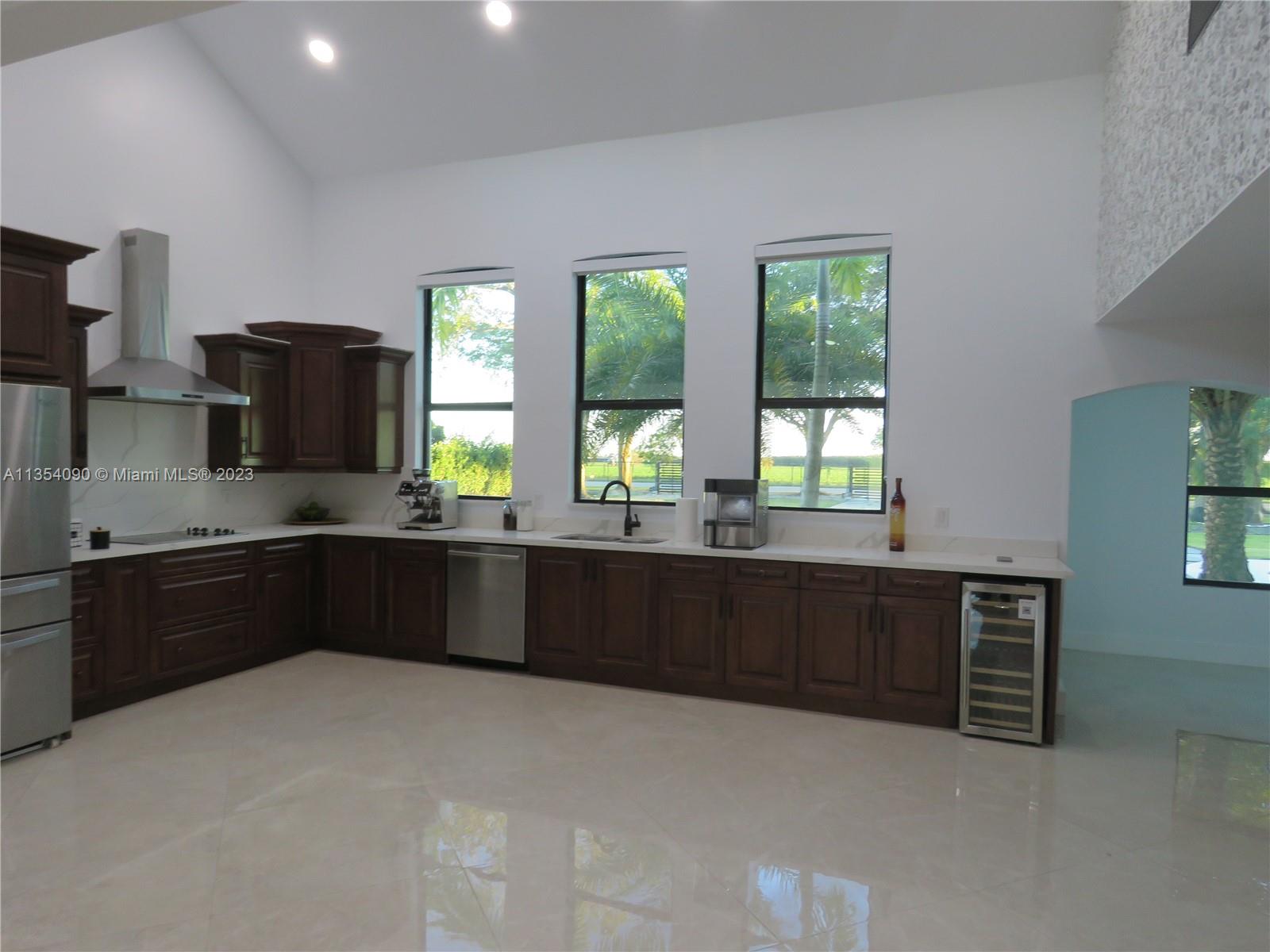 Redlands Homestead, FL 33031 - Photo 26 of 56 a kitchen with granite countertop a refrigerator and a sink