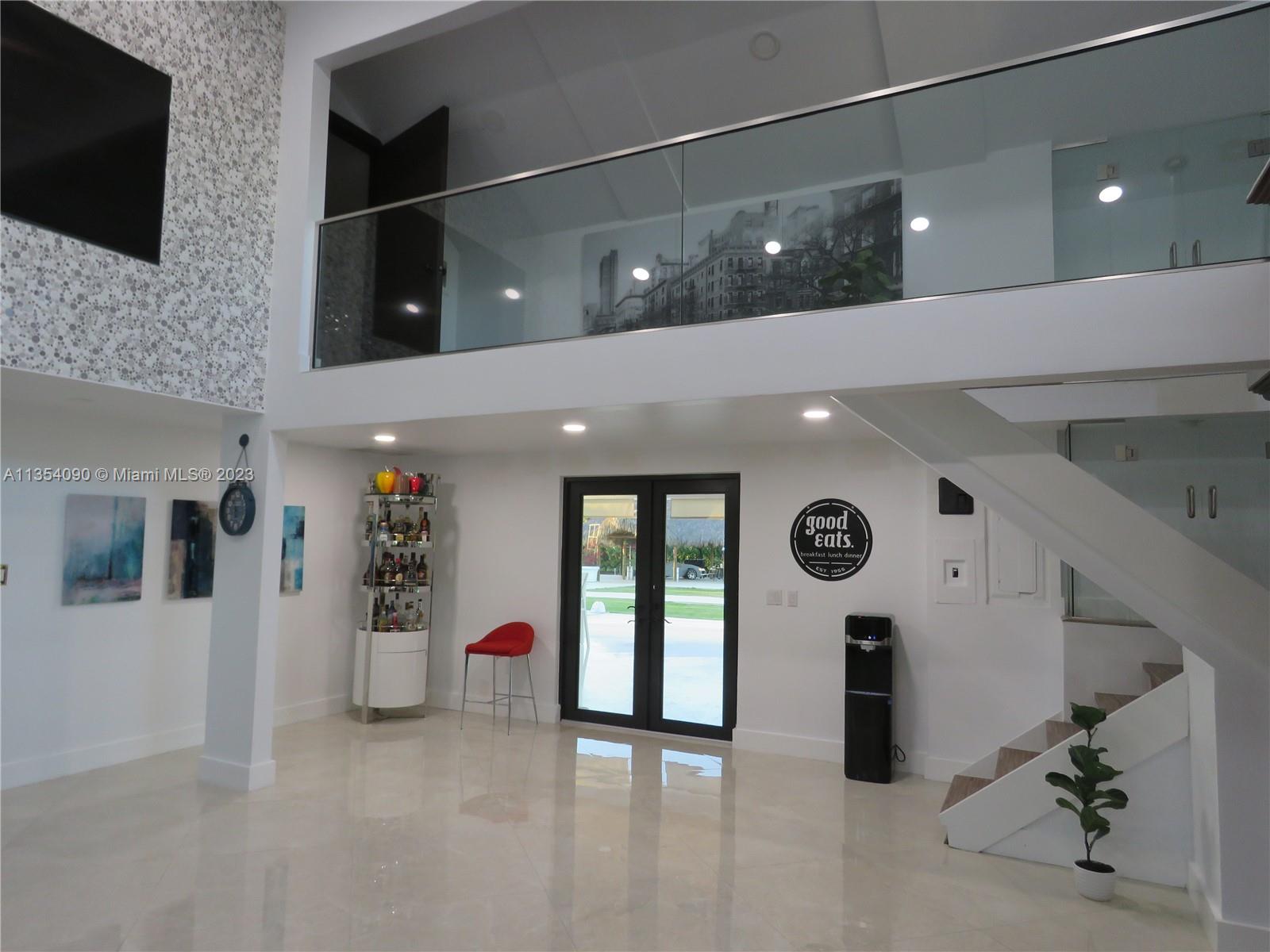 Redlands Homestead, FL 33031 - Photo 29 of 56 a lobby with furniture and flat screen tv