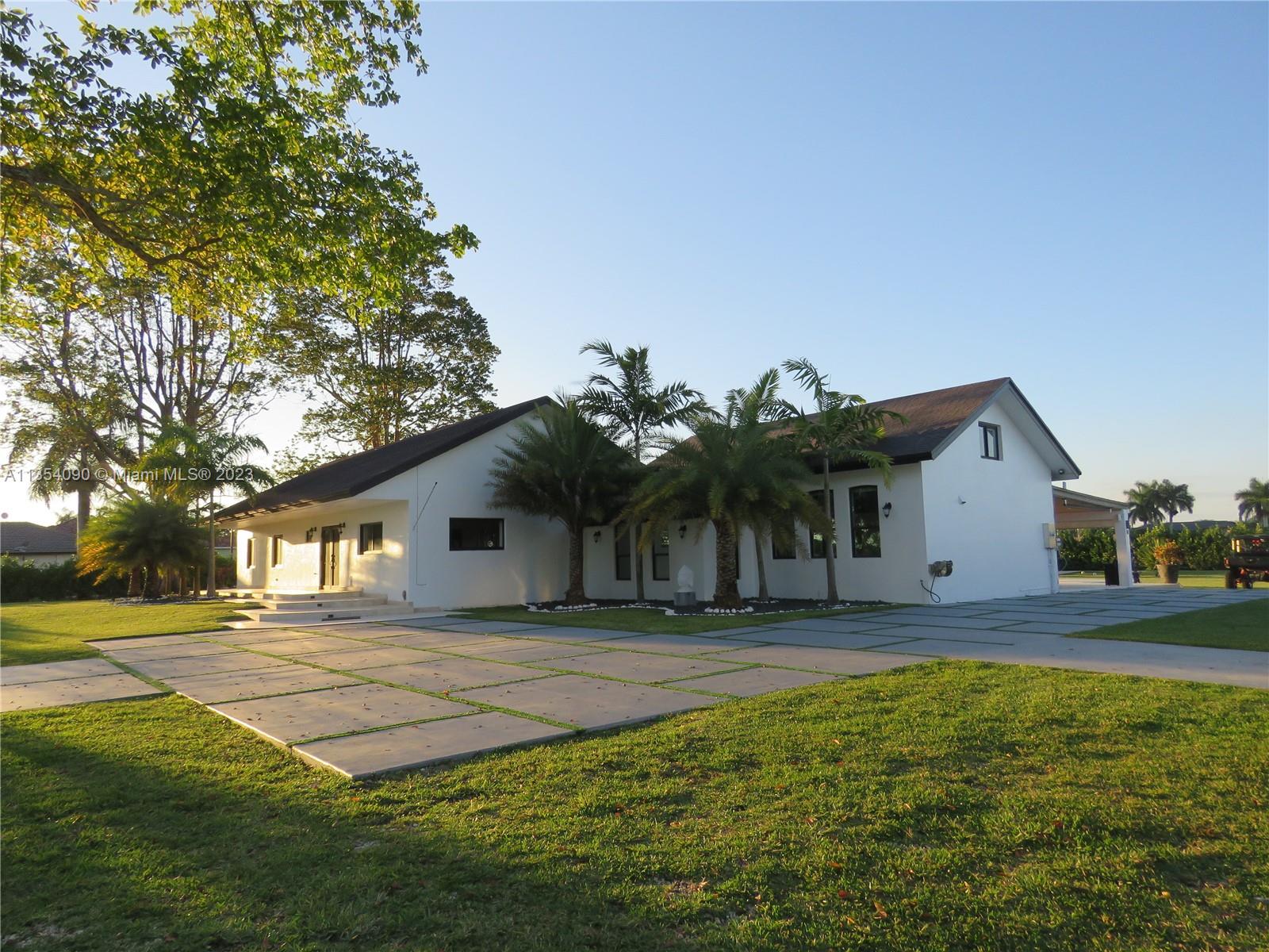 Redlands Homestead, FL 33031 - Photo 3 of 56 a front view of a house with a yard
