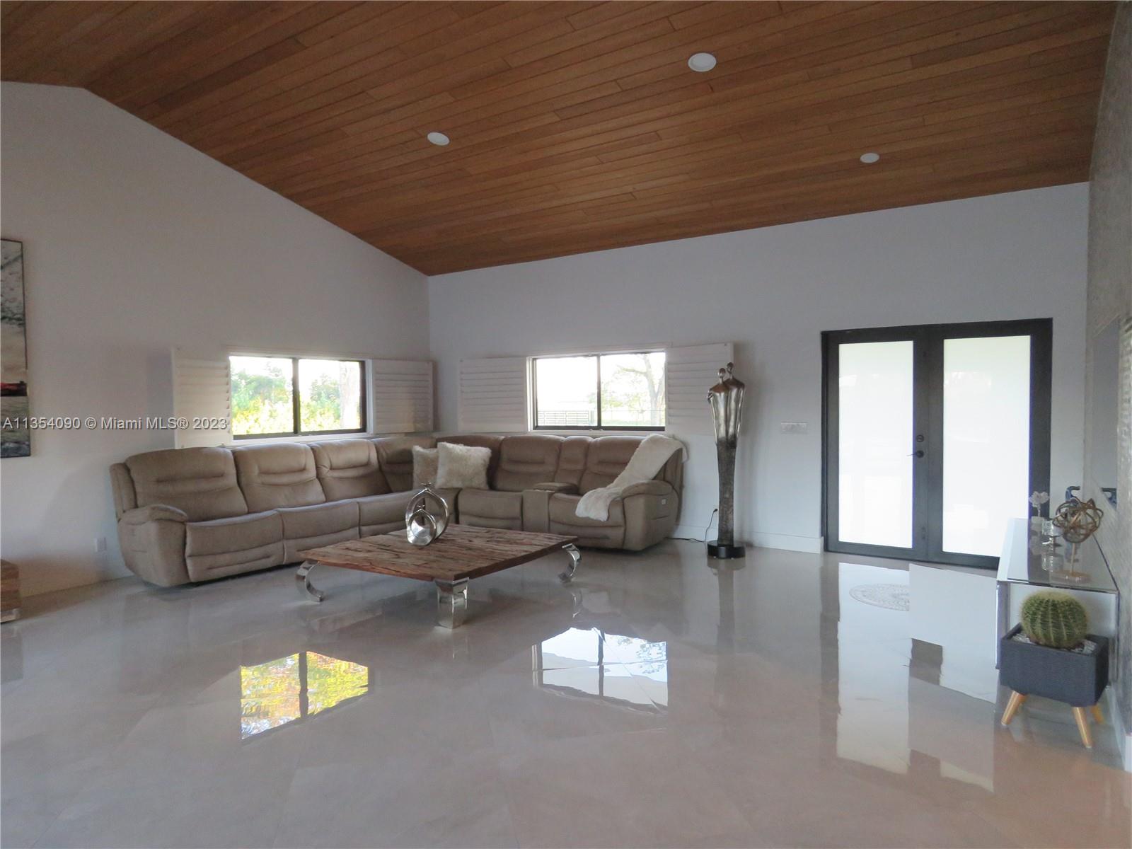 Redlands Homestead, FL 33031 - Photo 37 of 56 a living room with furniture and a large window