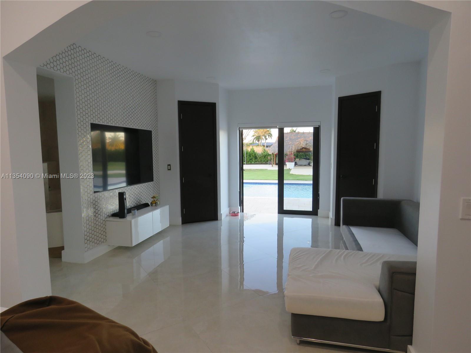 Redlands Homestead, FL 33031 - Photo 40 of 56 a living room with furniture and a flat screen tv