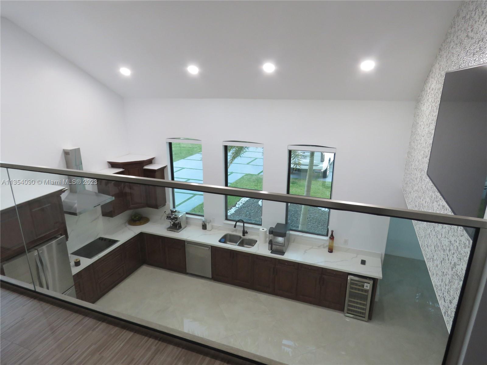 Redlands Homestead, FL 33031 - Photo 47 of 56 a hallway with a large mirror on a dresser with wooden floor