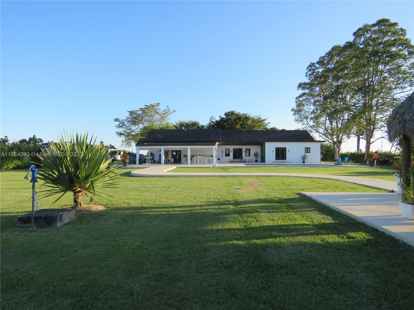 Redlands Homestead, FL 33031 - Photo 9 of 56 a front view of a house with a big yard