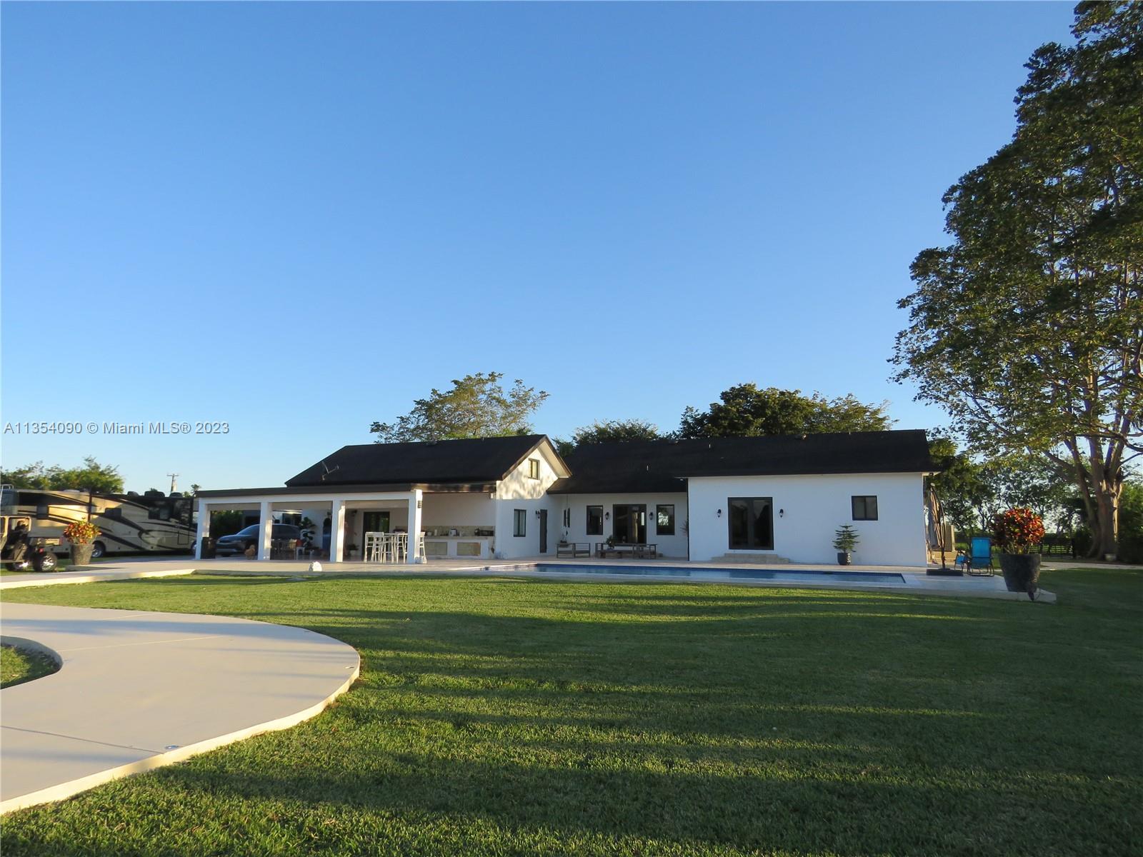 Redlands Homestead, FL 33031 - Photo 10 of 56 a front view of a house with a garden