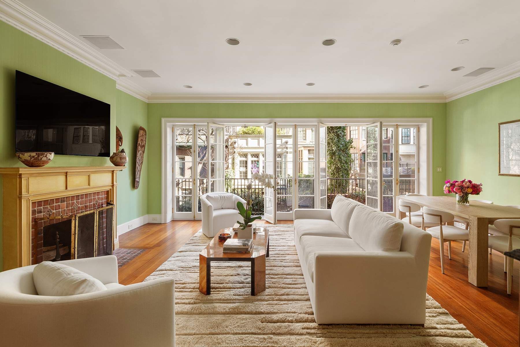 123 East 73rd Street Manhattan, NY 10021 - Photo 9 of 24 a living room with fireplace furniture and a flat screen tv