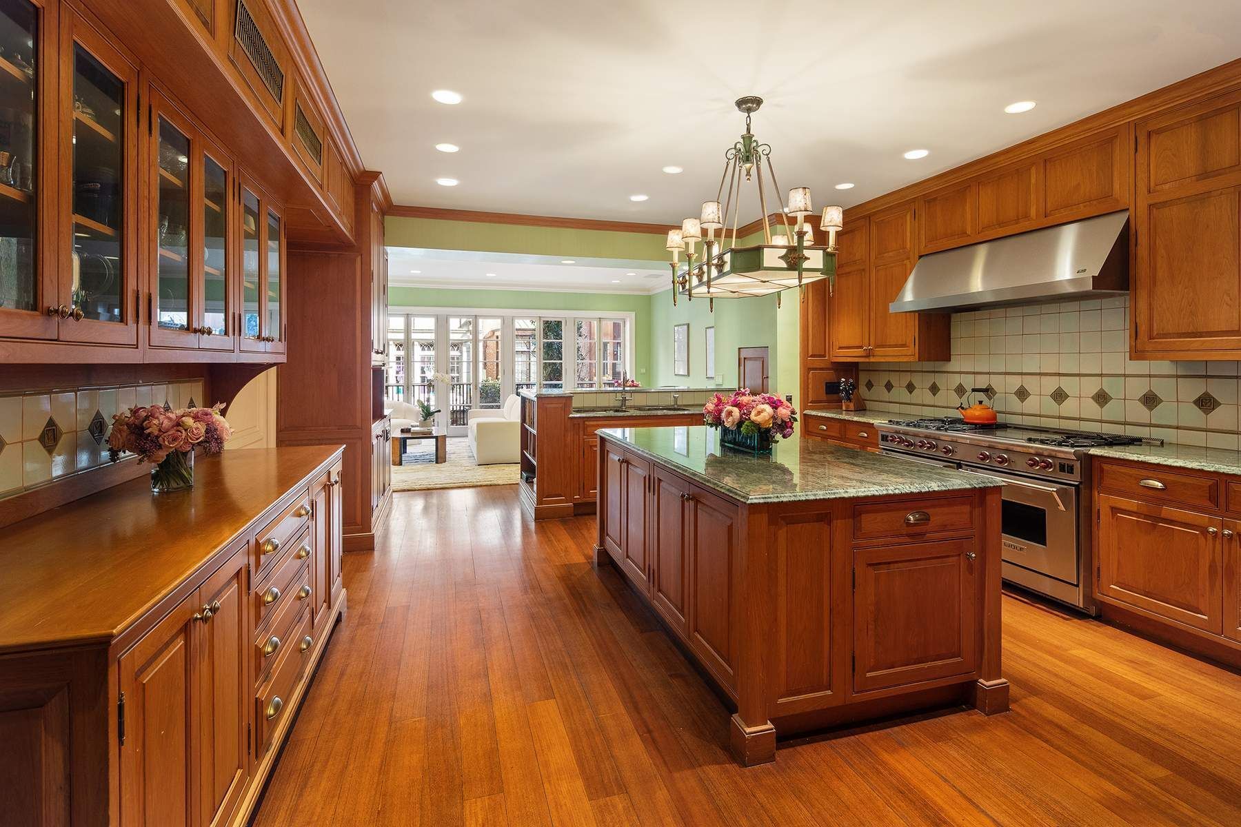 123 East 73rd Street Manhattan, NY 10021 - Photo 11 of 24 a kitchen with stainless steel appliances granite countertop a stove a sink dishwasher a refrigerator and a oven with wooden floor