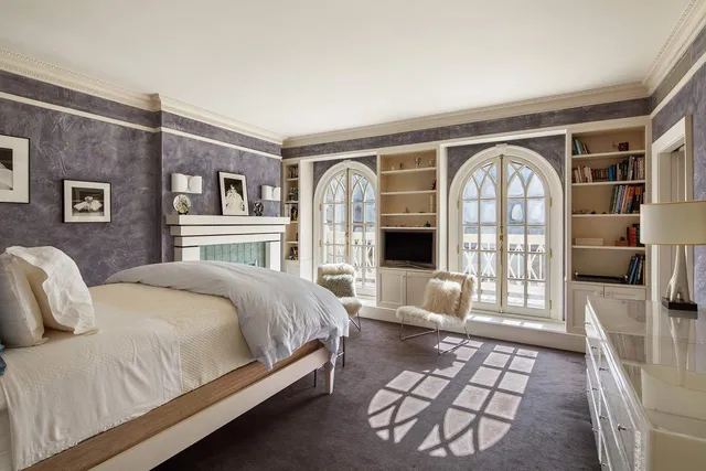 a spacious bedroom with a balcony a bed and a couch