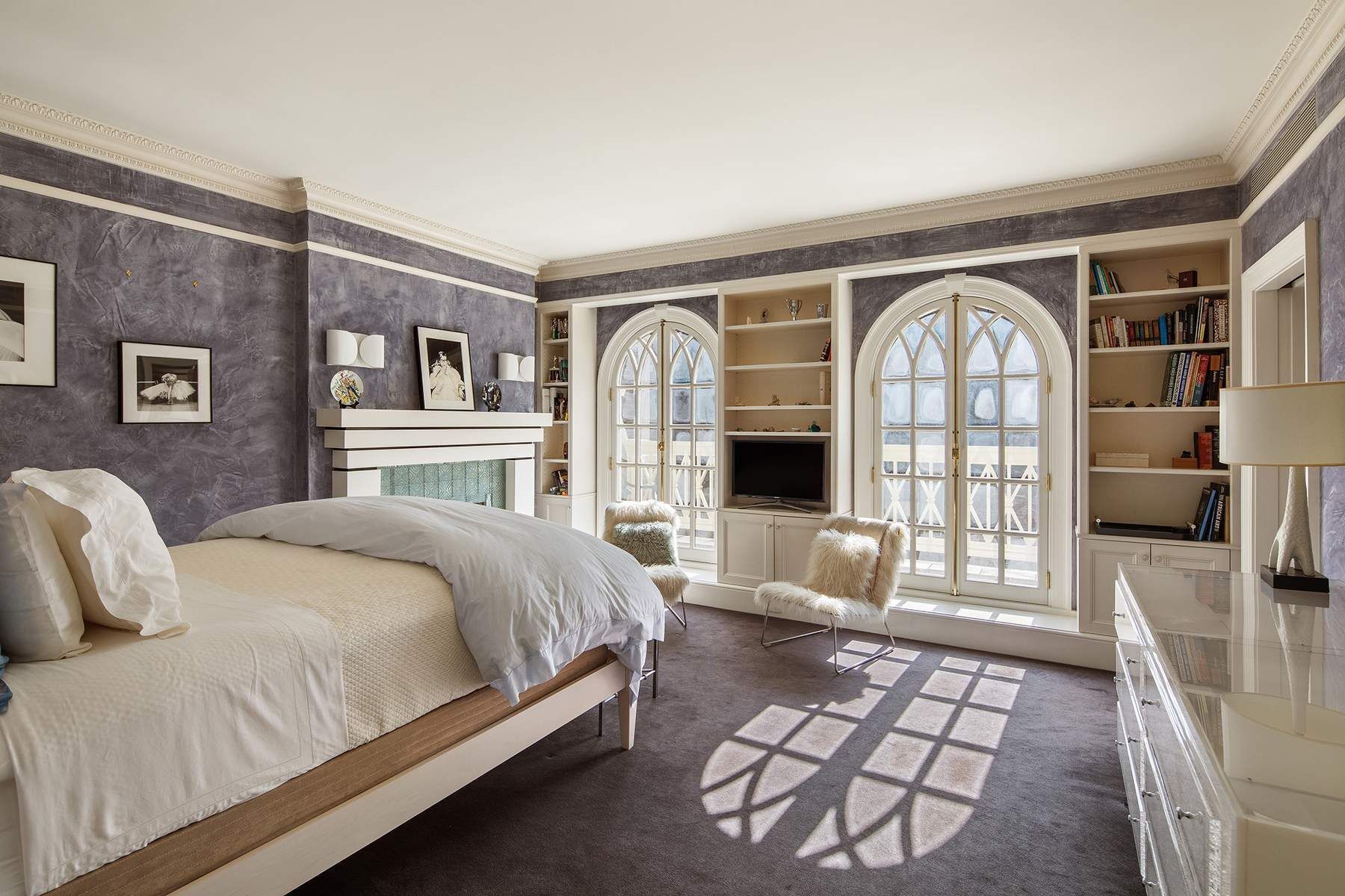 123 East 73rd Street Manhattan, NY 10021 - Photo 15 of 24 a spacious bedroom with a balcony a bed and a couch