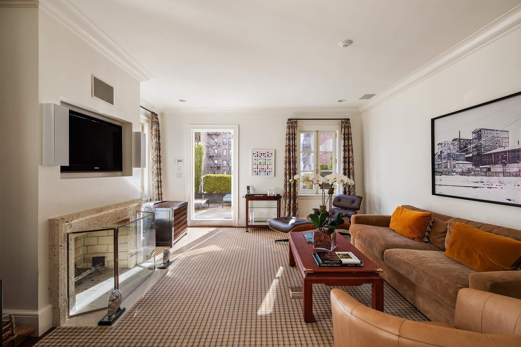 123 East 73rd Street Manhattan, NY 10021 - Photo 16 of 24 a living room with furniture a flat screen tv and a fireplace