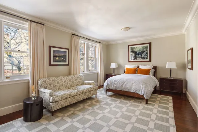 a bedroom with a bed and a couch