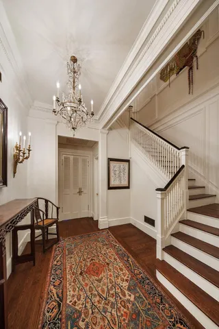 a view of a livingroom with wooden floor and stairs