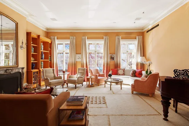 a living room with furniture and large windows