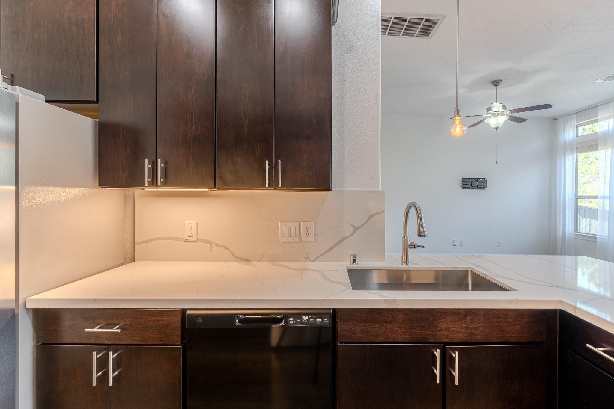 58 Aventura Place Spring, TX 77389 - Photo 9 of 23 a kitchen with a sink and cabinets