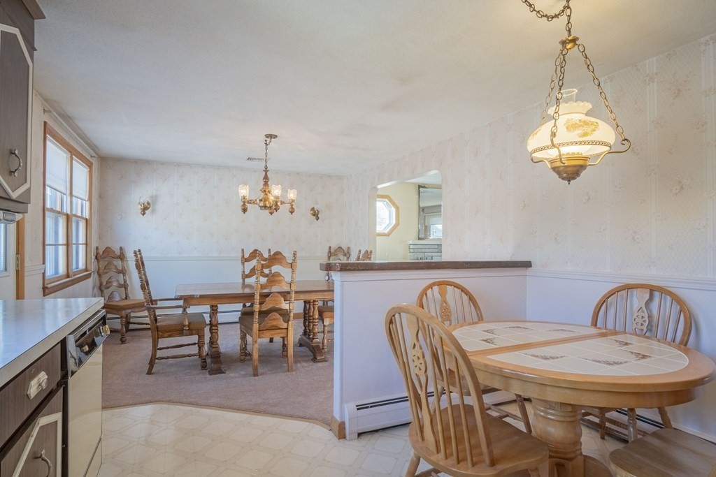 1 Christopher Drive Nahant, MA 01908 - Photo 17 of 41 a dining room with furniture a chandelier and a rug
