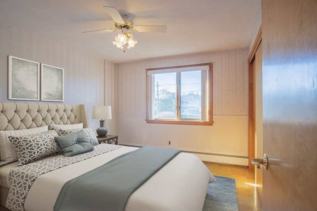1 Christopher Drive Nahant, MA 01908 - Photo 21 of 41 a bedroom with a bed and a chandelier