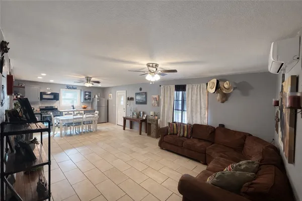 a living room with furniture a dining table and a fireplace