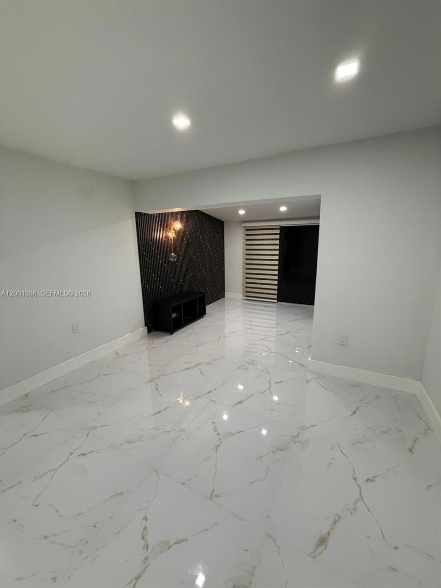 10460 Southwest 26th Terrace Miami, FL 33165 - Photo 15 of 28 a view of a livingroom with an empty space and a fireplace