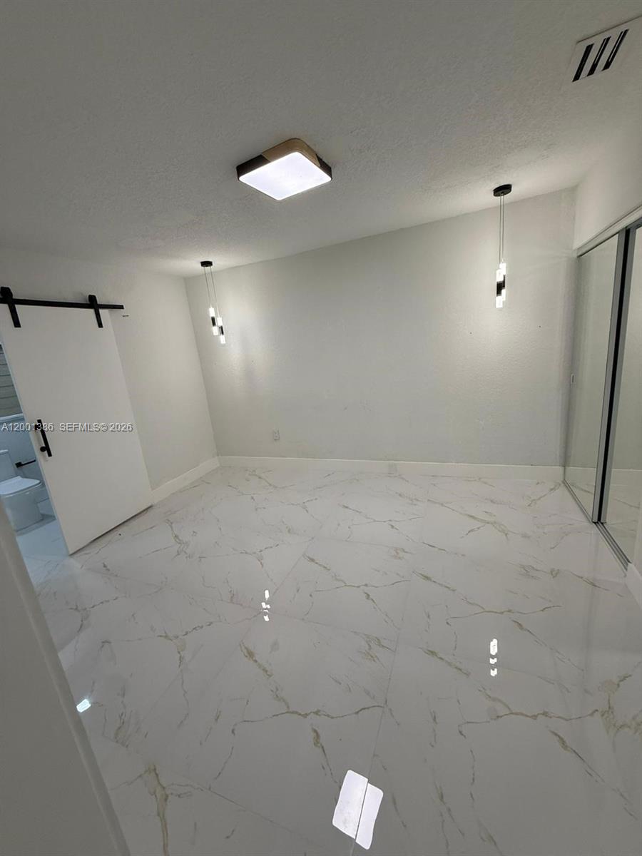 10460 Southwest 26th Terrace Miami, FL 33165 - Photo 16 of 28 an empty room with white walls and tiles