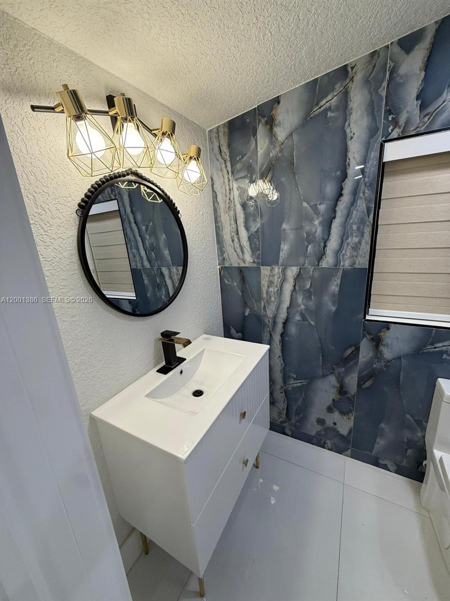 10460 Southwest 26th Terrace Miami, FL 33165 - Photo 18 of 28 a bathroom with a sink and mirror