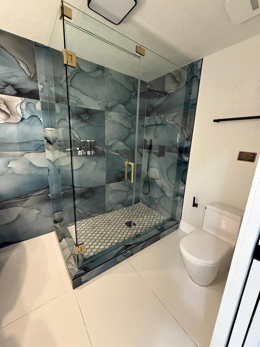 10460 Southwest 26th Terrace Miami, FL 33165 - Photo 20 of 28 a bathroom with a shower and a toilet