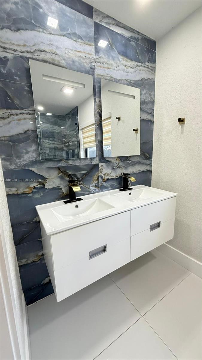 10460 Southwest 26th Terrace Miami, FL 33165 - Photo 25 of 28 a bathroom with a sink and a mirror