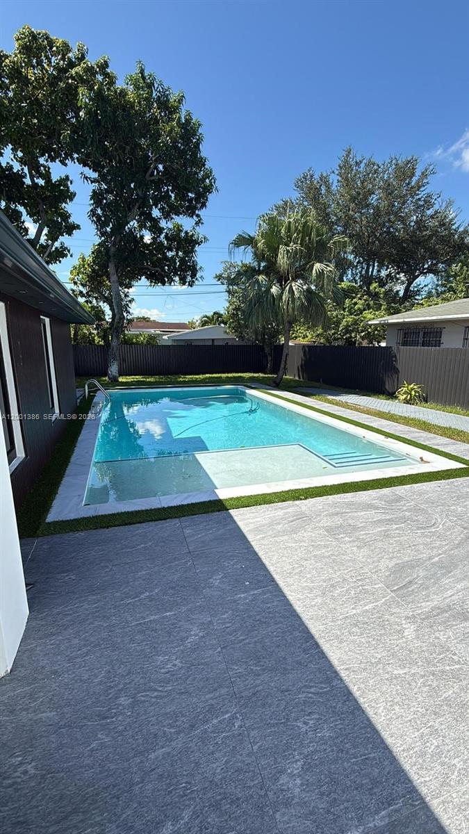 10460 Southwest 26th Terrace Miami, FL 33165 - Photo 28 of 28 a view of a swimming pool with an outdoor space and seating area