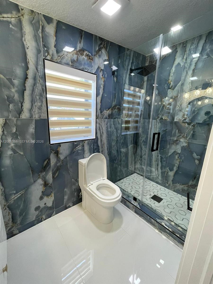 10460 Southwest 26th Terrace Miami, FL 33165 - Photo 3 of 28 a bathroom with a sink toilet and shower