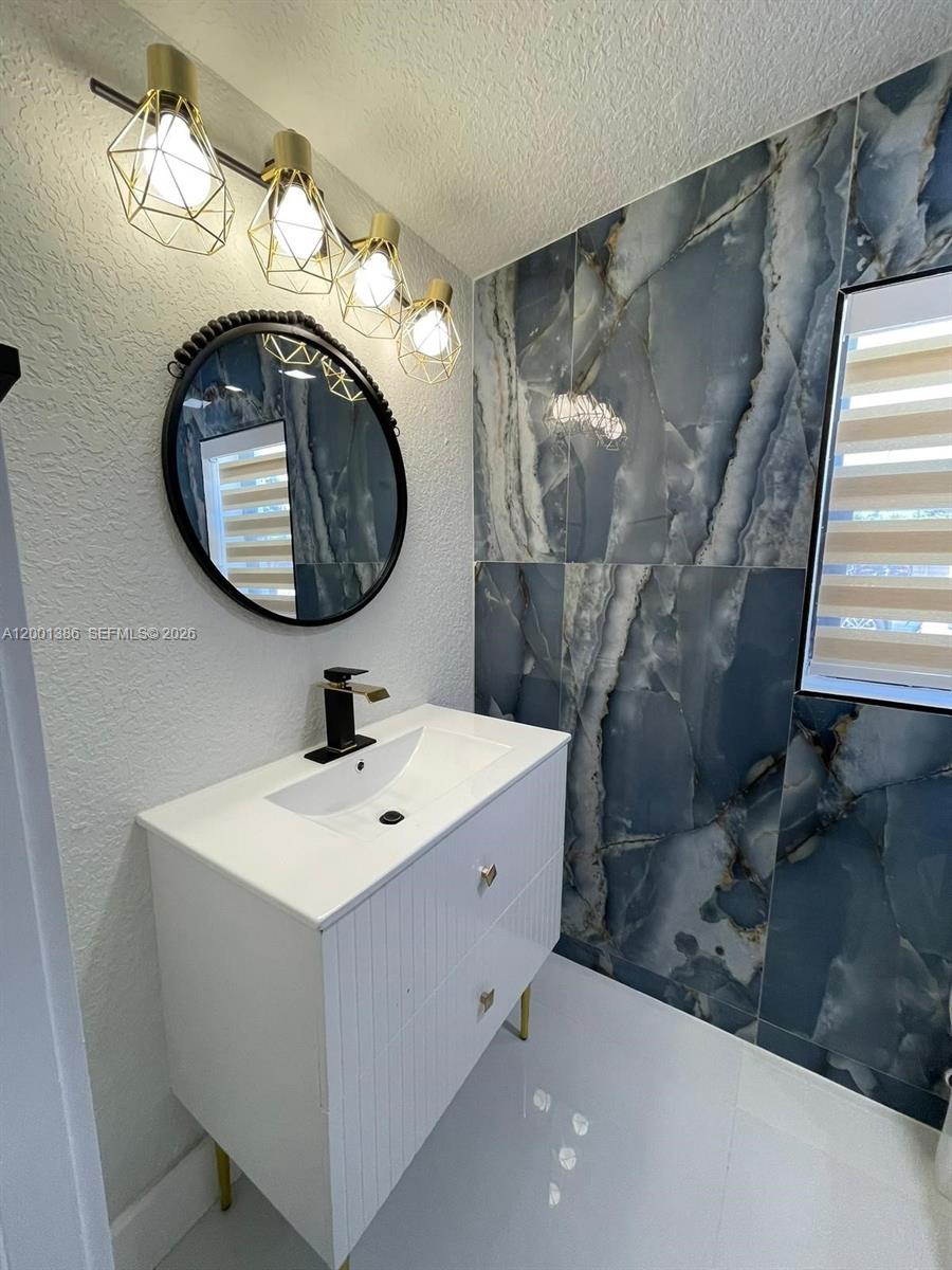 10460 Southwest 26th Terrace Miami, FL 33165 - Photo 5 of 28 a bathroom with a sink and a mirror