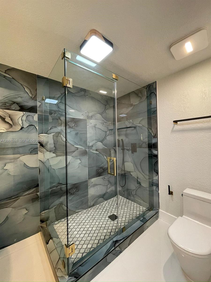 10460 Southwest 26th Terrace Miami, FL 33165 - Photo 6 of 28 a bathroom with a shower and a toilet