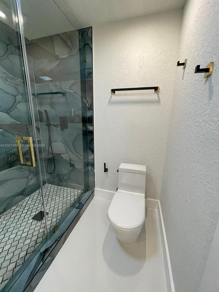 10460 Southwest 26th Terrace Miami, FL 33165 - Photo 8 of 28 a bathroom with a toilet and a shower
