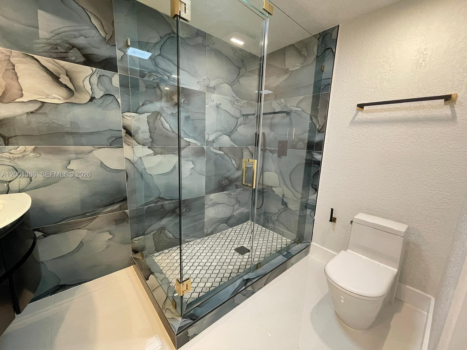 10460 Southwest 26th Terrace Miami, FL 33165 - Photo 9 of 28 a bathroom with a toilet and a shower