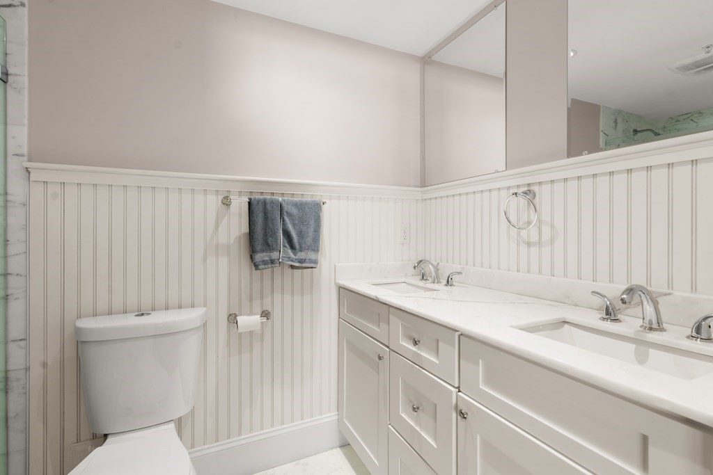 215 Athens Street, Unit 4 Boston, MA 02127 - Photo 11 of 15 a bathroom with a sink a toilet and shower