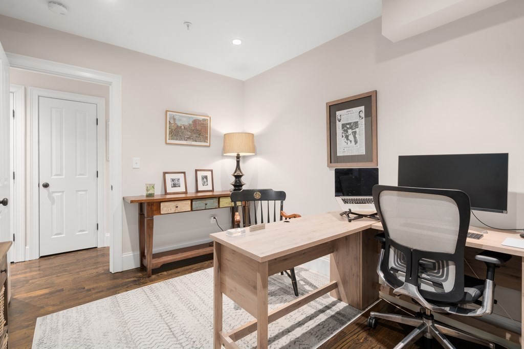 215 Athens Street, Unit 4 Boston, MA 02127 - Photo 12 of 15 a work room with furniture and a wooden floor